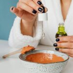Close-up of lecithin granules beside a jar of creamy homemade emulsion