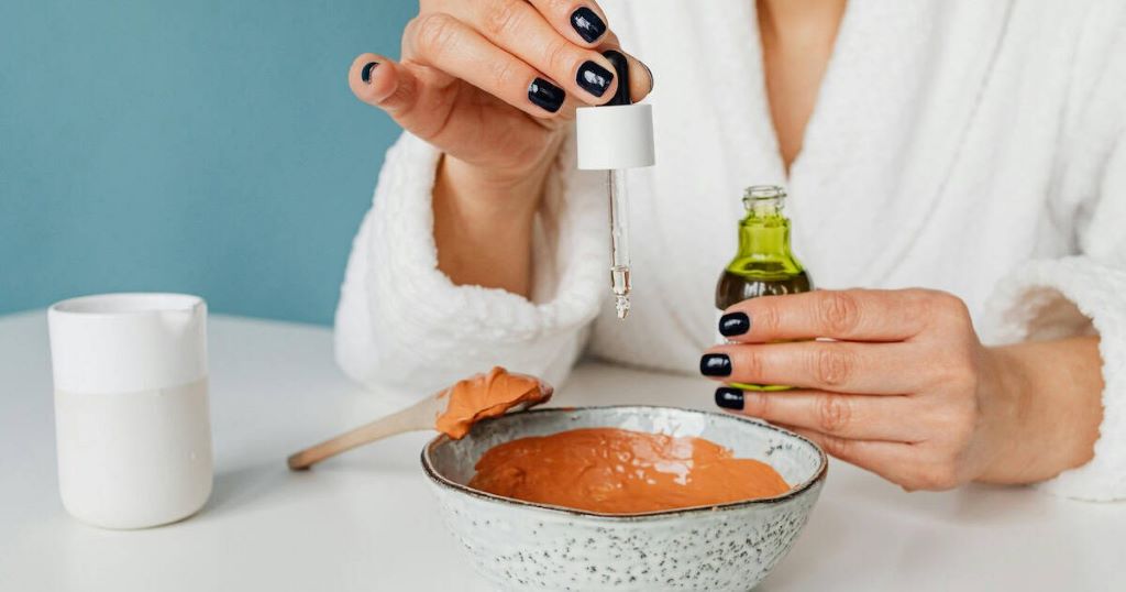 Close-up of lecithin granules beside a jar of creamy homemade emulsion
