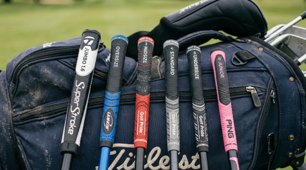 Close-up of different golf grip sizes laid out for comparison on a golf bag