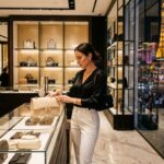 Shopper browsing designer handbags inside a luxury boutique on the Las Vegas Strip in Nevada